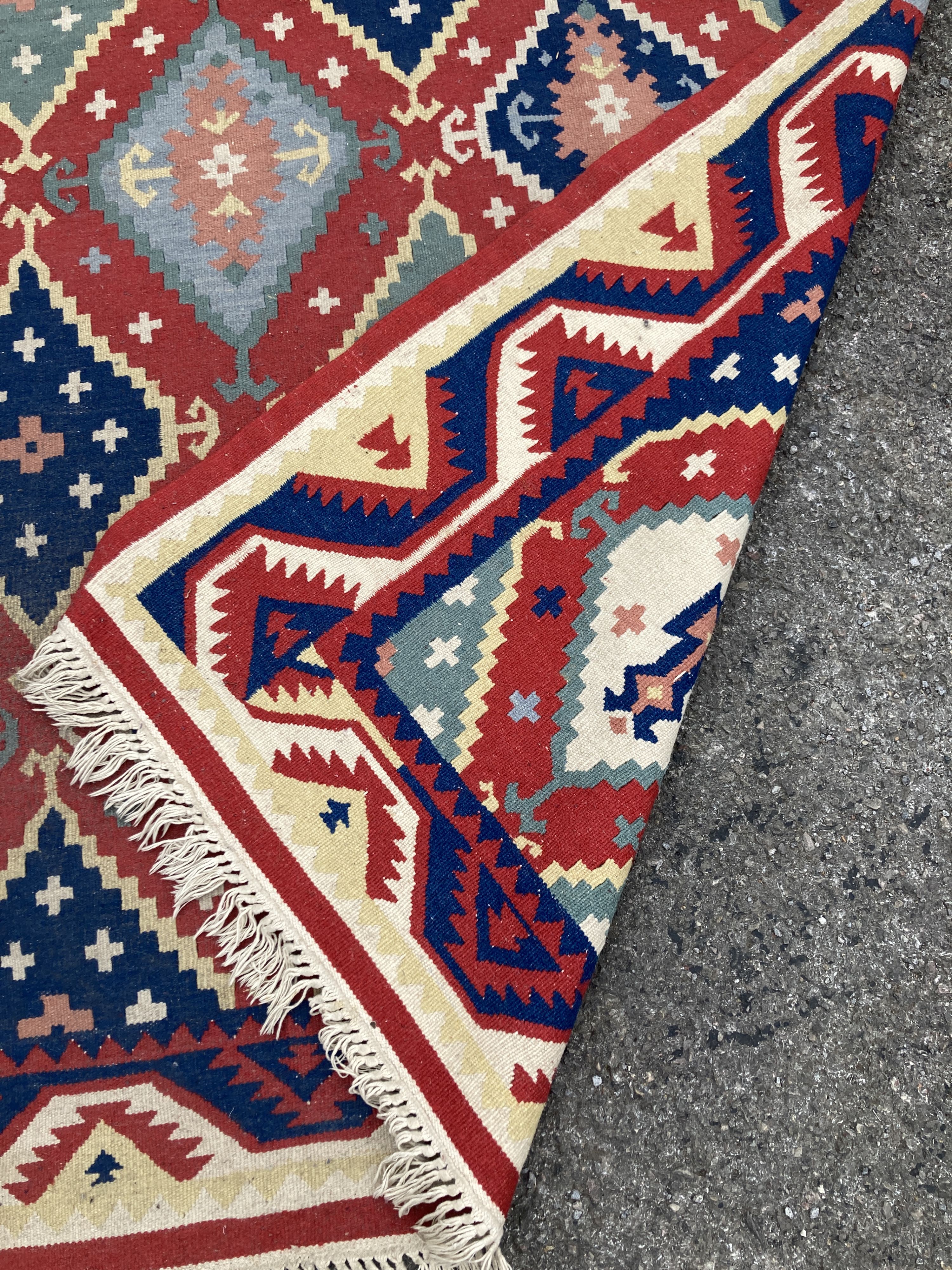 A Kelim flatweave polychrome geometric carpet, 240 x 160cm
